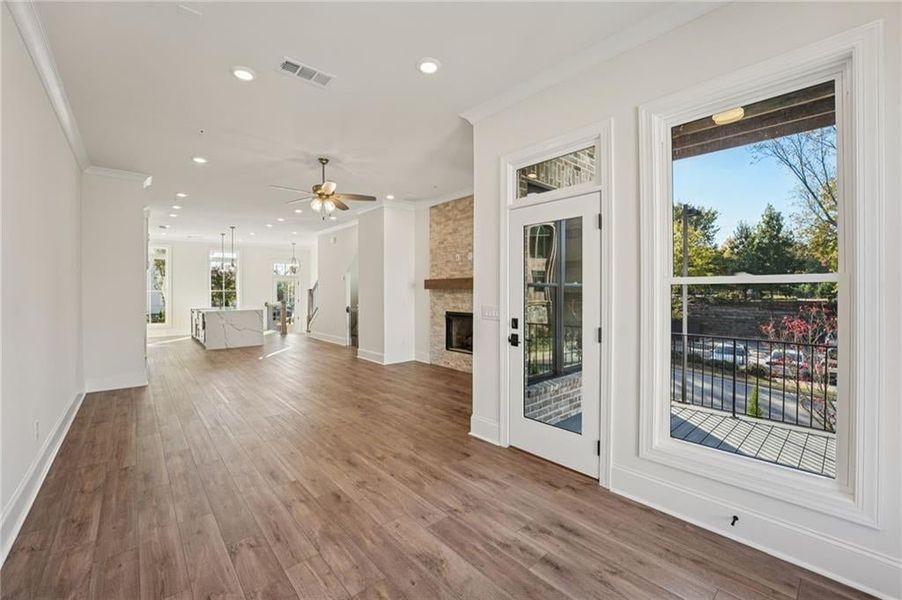 Sunroom space gives you access to your private back deck on the Main level space- this unit is an End Unit so the deck space is open on 2 sides- brining in so much natural light.  Image is of a previously built Chamberlain Plan