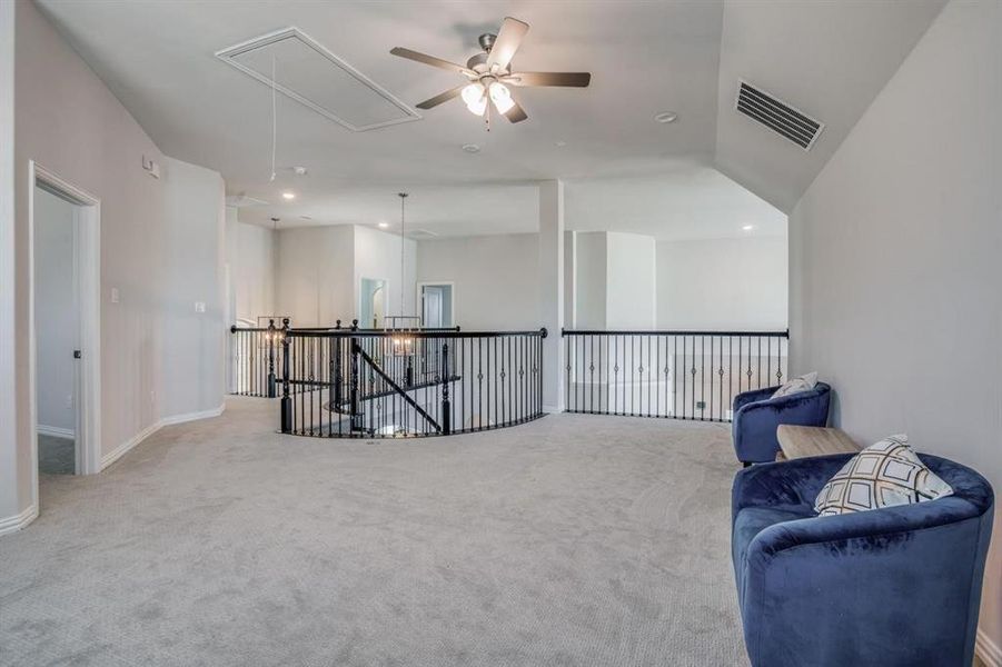 Sitting room with lofted ceiling, light carpet, and ceiling fan