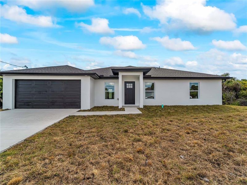 Front exterior of a new home in , Port Charlotte, FL, highlighting curb appeal (Image 24).