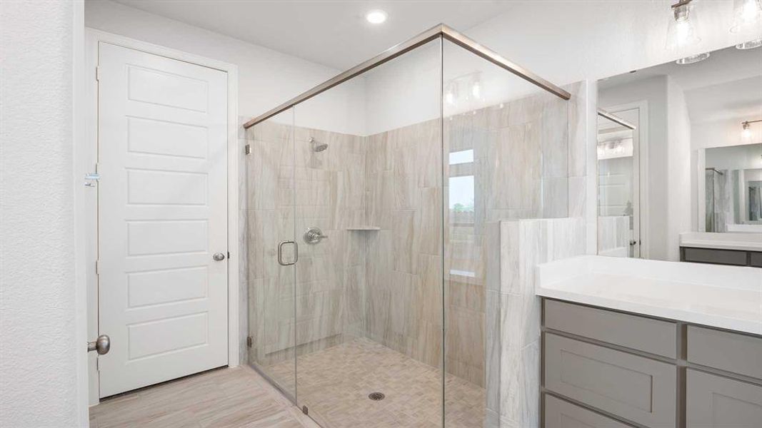 Bathroom with a shower with door and vanity