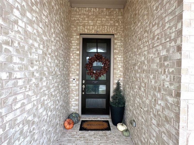 Entrance to property with brick siding