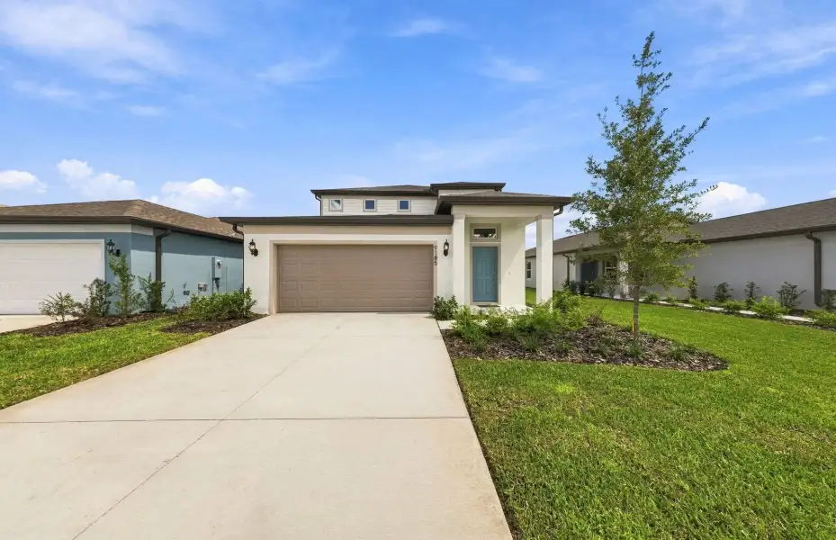 Front exterior of a new home in Twisted Oaks, Wildwood, FL, highlighting curb appeal (Image 1). Front exterior of a new home in Twisted Oaks, Wildwood, FL, highlighting curb appeal (Image 1).
