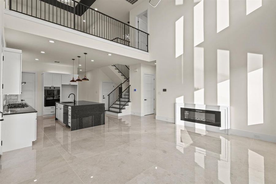 Living room featuring sink and a towering ceiling