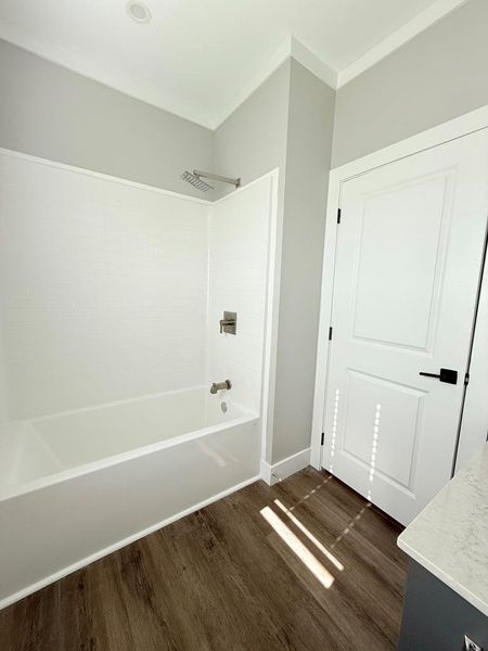 A well-appointed bath with modern fixtures and durable wood-look flooring. Bathroom 3