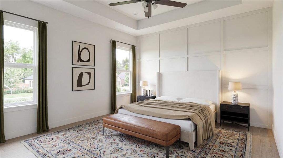 Bedroom featuring a tray ceiling, ceiling fan, and light wood-finish flooring Bedroom featuring a tray ceiling, ceiling fan, and light wood-finish flooring