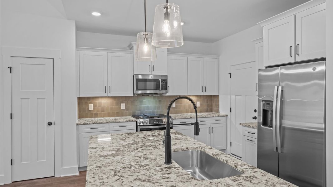 First-rate kitchen with a smaller island and superior cabinetry in a thoughtfully designed space