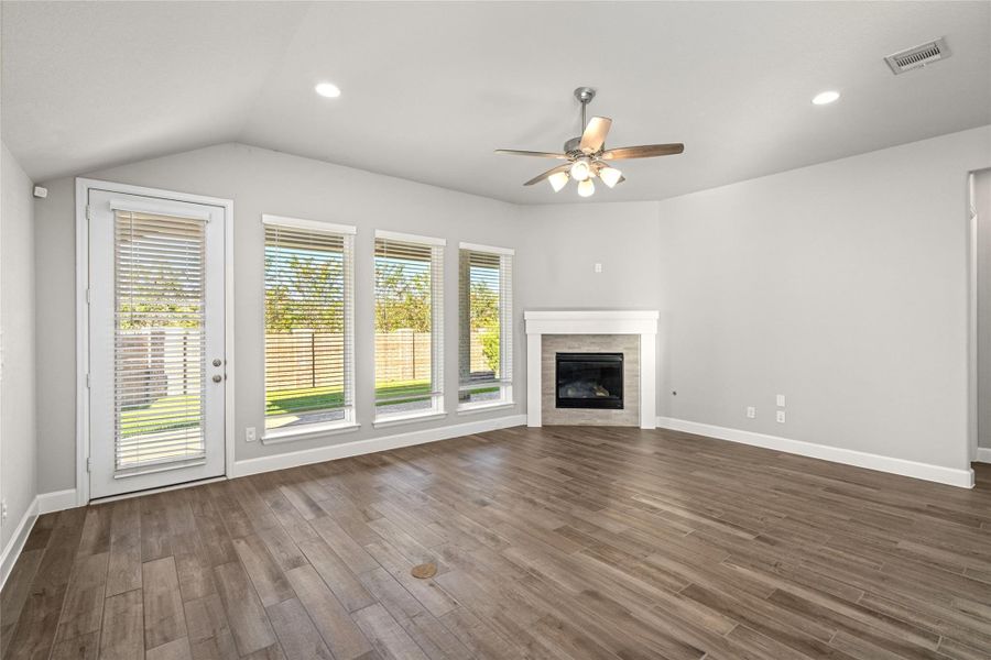 Cozy yet elegant Family Room anchored by the modern gas Fireplace with a wood mantel.