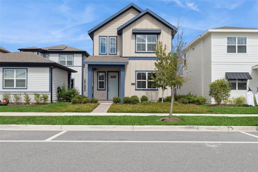 Front exterior of a new home in Weslyn Park at Sunbridge (Craft Homes), St. Cloud, FL, highlighting curb appeal (Image 2).