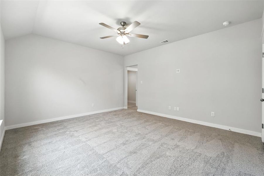 Spare room featuring ceiling fan and carpet flooring