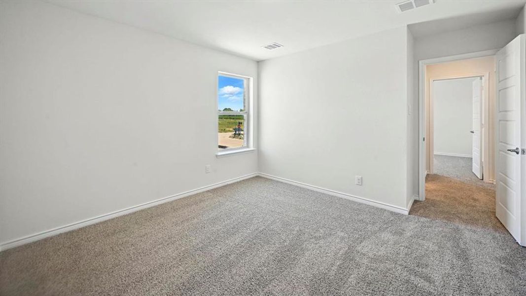 Unfurnished room featuring light carpet and baseboards Unfurnished room featuring light carpet and baseboards