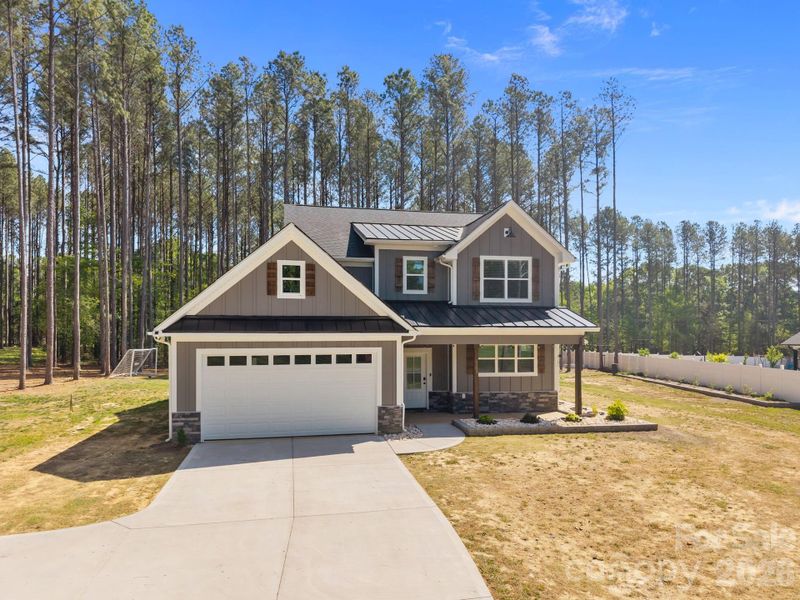 Front exterior of a new home in , Monroe, NC, highlighting curb appeal (Image 24).