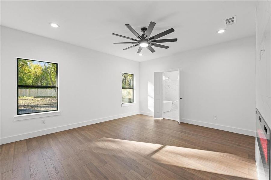 Spare room with hardwood / wood-style floors and ceiling fan