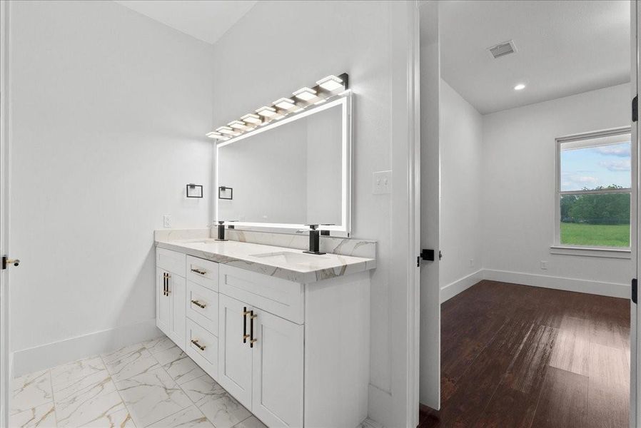 Primary bath with dual sinks and oversized vanity.