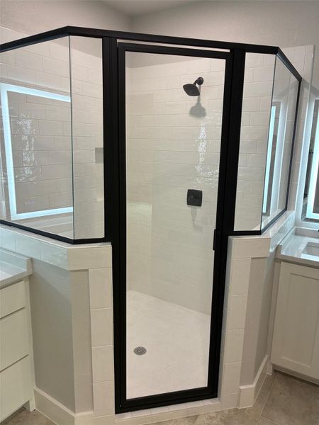 Step into a modern glass shower enclosure with crisp tile work and sleek fixtures. Step into a modern glass shower enclosure with crisp tile work and sleek fixtures.