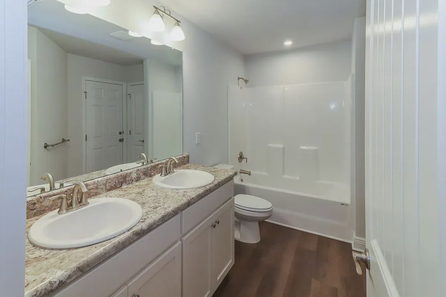 Representative furnished interior of a home built from the Plan 2502 by Adams Homes in Cedar Creek at Deerpoint Lake, Panama City (Image 12).