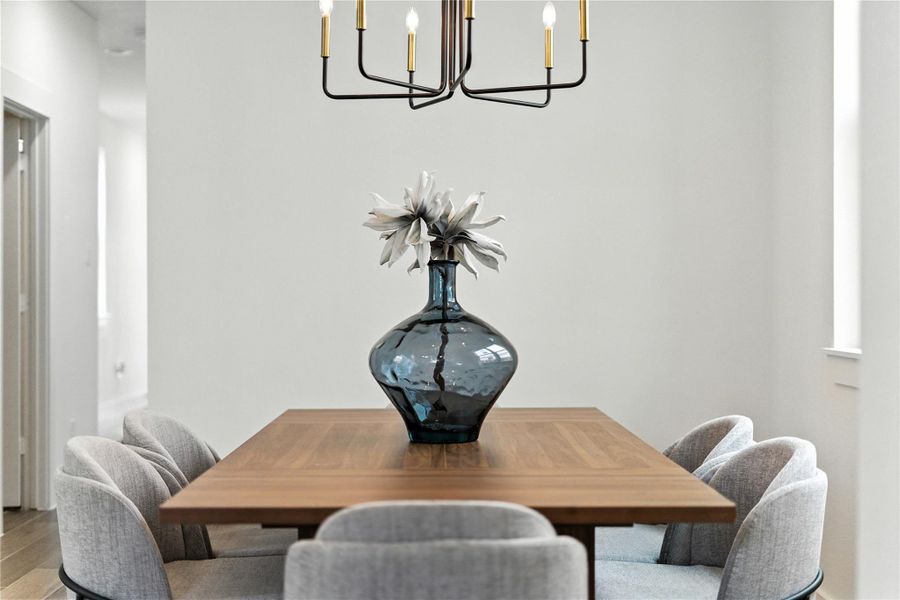 Dining area sits just off the kitchen with a stylish chandelier overhead! Peep the spacious pantry to the right and the door leading to your covered back patio! Dining area sits just off the kitchen with a stylish chandelier overhead! Peep the spacious pantry to the right and the door leading to your covered back patio!