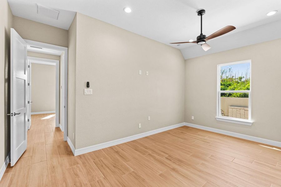 This alternate perspective highlights the room’s natural lighting and open layout, showcasing a relaxing space ideal for guests or family members.