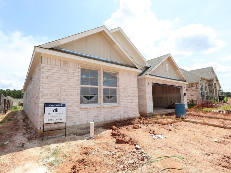 Front exterior of a new home in Magnolia Ridge, Magnolia, TX, highlighting curb appeal (Image 12).