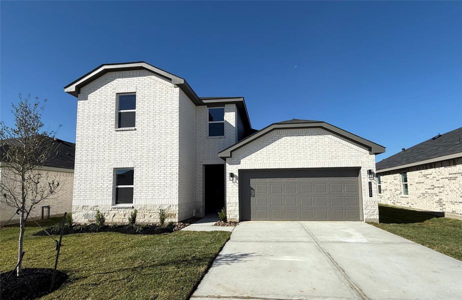 Front exterior of a new home in Porters Mill, New Caney, TX, highlighting curb appeal (Image 1). Front exterior of a new home in Porters Mill, New Caney, TX, highlighting curb appeal (Image 1).