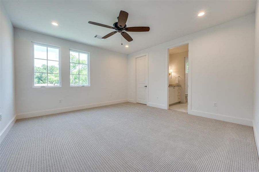 Unfurnished bedroom featuring light carpet, recessed lighting, connected bathroom, and ceiling fan Unfurnished bedroom featuring light carpet, recessed lighting, connected bathroom, and ceiling fan