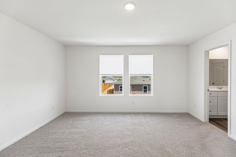 Unfurnished bedroom with carpet and ensuite bathroom