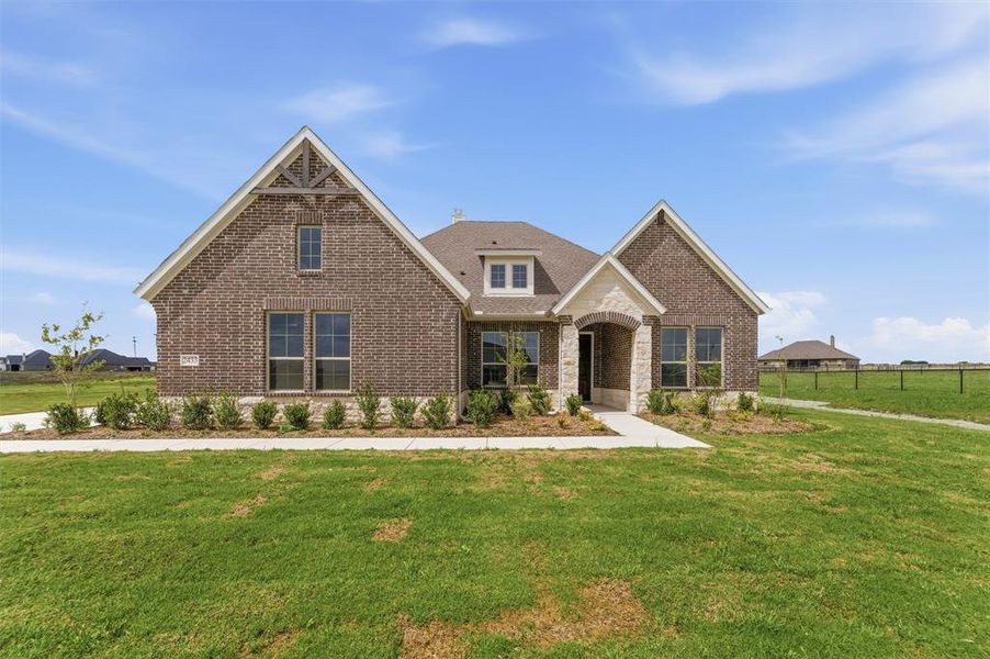 Brick exterior with stone accents and multiple gables