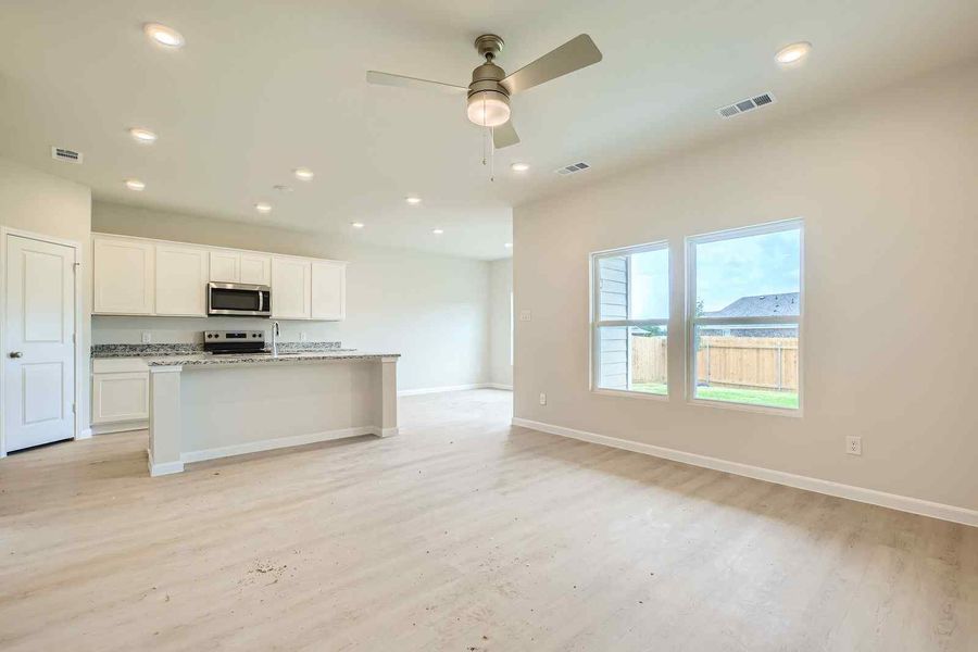 A kitchen with a large window.