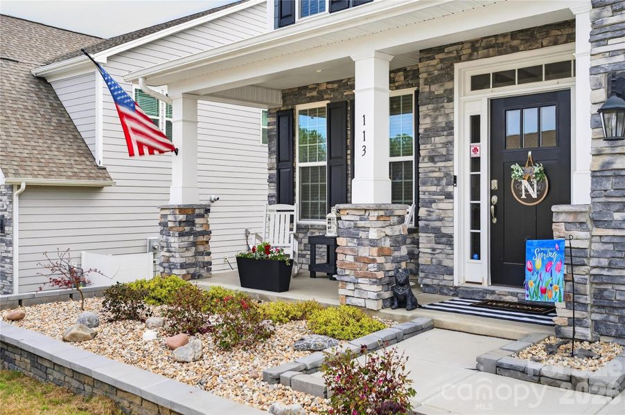 Custom landscaping and covered front porch.