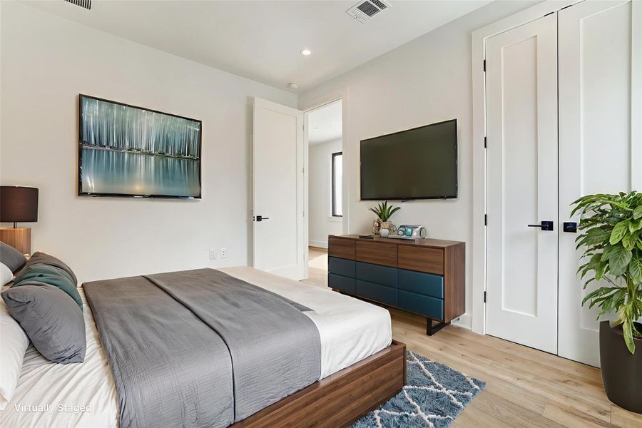 Bedroom featuring light wood-style flooring and recessed lighting Bedroom featuring light wood-style flooring and recessed lighting