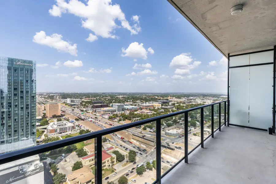 A spacious private balcony provides breathtaking cityscape views.