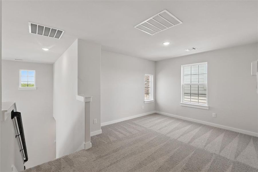 Spare room with recessed lighting and light colored carpet