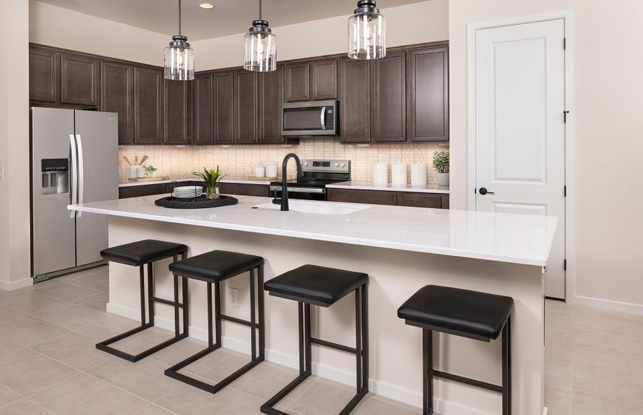 Open kitchen with large island in Prato new home construction at Jorde Farms in Queen Creek, AZ Open kitchen with large island in Prato new home construction at Jorde Farms in Queen Creek, AZ