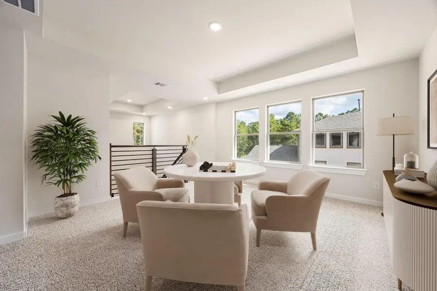 An inviting upstairs loft with plenty of natural light, offering a flexible space that can be used as a game room, media area, or home office. An inviting upstairs loft with plenty of natural light, offering a flexible space that can be used as a game room, media area, or home office.