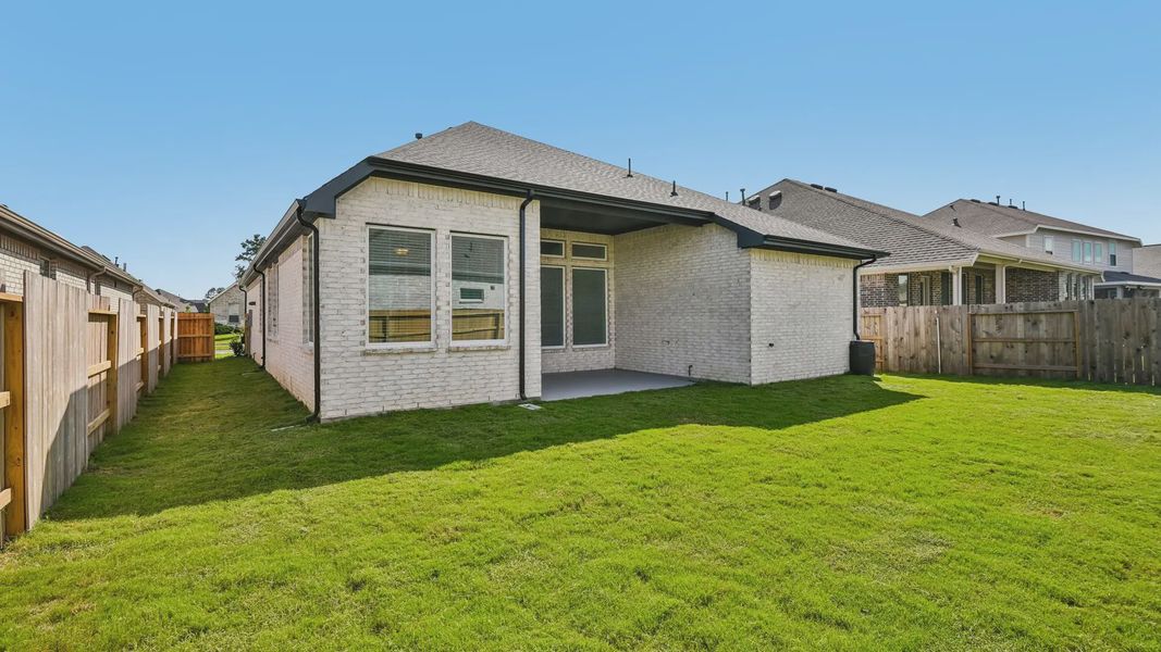 Exterior details and patio area of a home in Artavia, Conroe (Image 24).