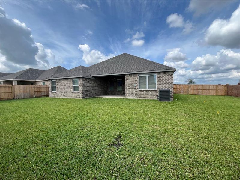 The spacious backyard is fully sodded, has a built in sprinkler system, and features covered patio with modern ceiling fan.