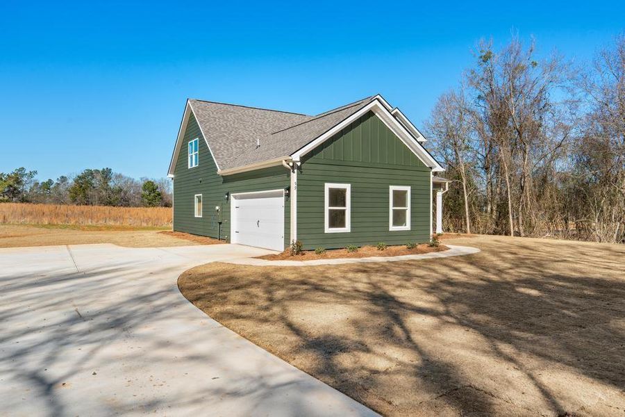 Front exterior of a new home in , Locust Grove, GA, highlighting curb appeal (Image 20).