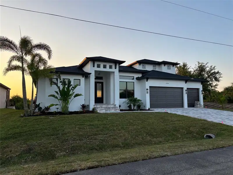 Front exterior of a new home in , Port Charlotte, FL, highlighting curb appeal (Image 1). Front exterior of a new home in , Port Charlotte, FL, highlighting curb appeal (Image 1).
