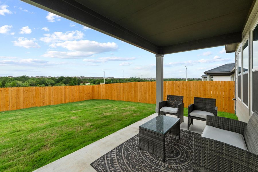 Step outside onto the covered back patio, an ideal spot for setting up a couple of chairs and a grill to relax in the shade Step outside onto the covered back patio, an ideal spot for setting up a couple of chairs and a grill to relax in the shade