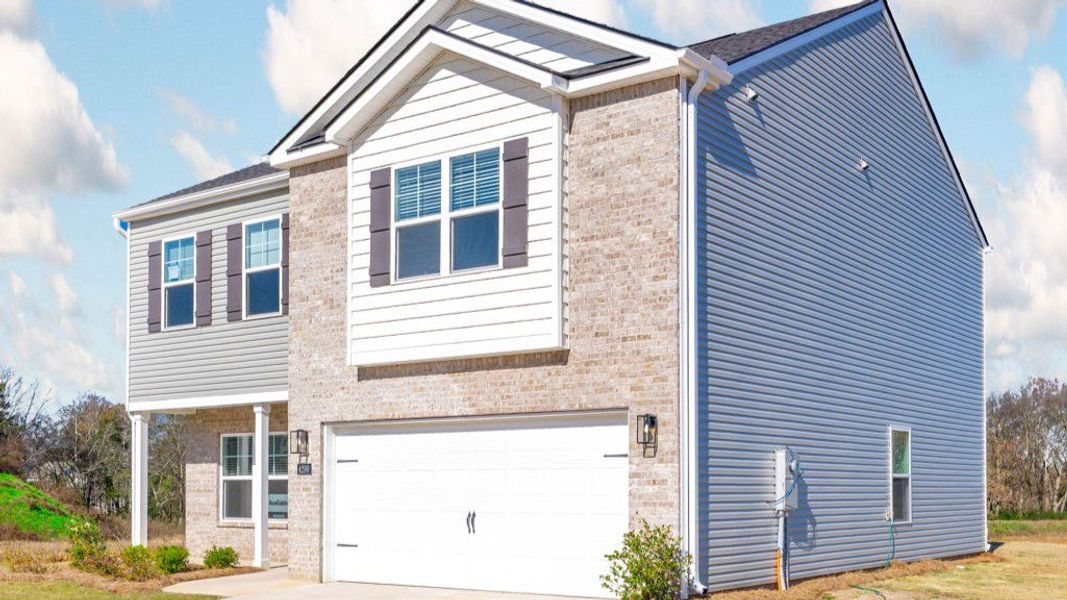Front exterior of a new home in Lone Oaks Farm, Cleveland, TN, highlighting curb appeal (Image 14). Front exterior of a new home in Lone Oaks Farm, Cleveland, TN, highlighting curb appeal (Image 14).