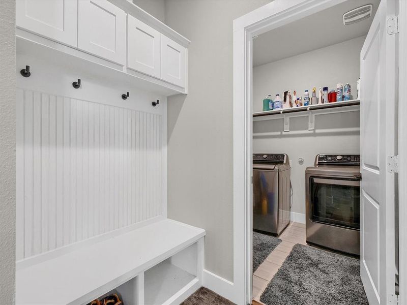 Mudroom featuring light wood-type flooring and washing machine and clothes dryer Mudroom featuring light wood-type flooring and washing machine and clothes dryer
