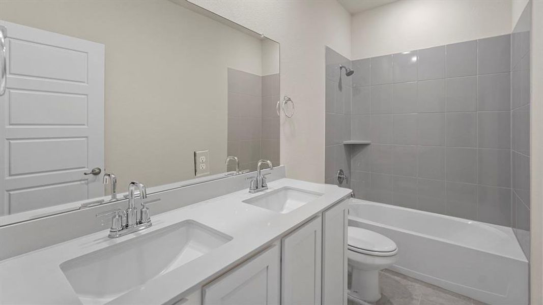 Full bath featuring double vanity and shower combination Full bath featuring double vanity and shower combination