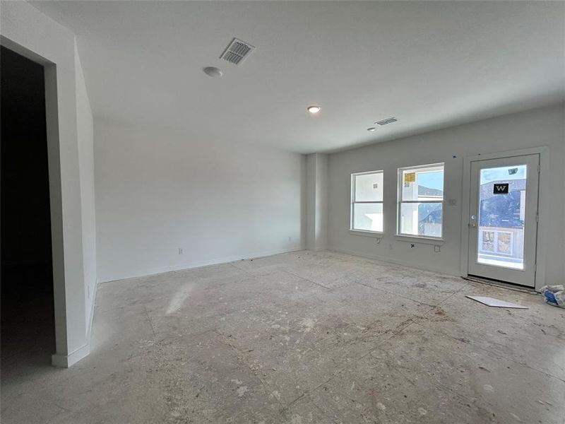 The empty game room is a wide, open space, ready to be filled with game tables, consoles, and seating for hours of fun and entertainment.