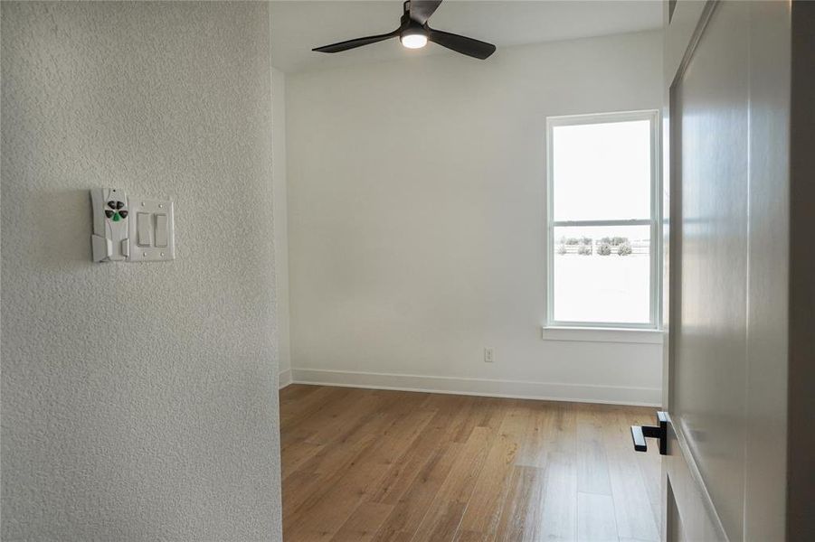 Spare room featuring ceiling fan and light hardwood / wood-style floors