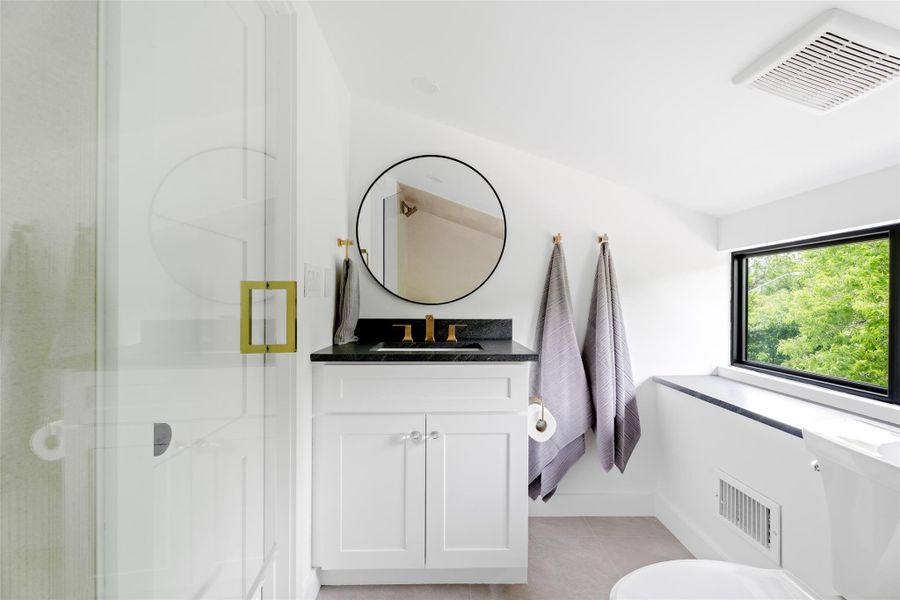Full bath with vanity, tile patterned flooring, a stall shower, and visible vents