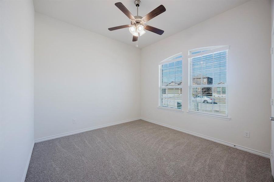 Spare room featuring ceiling fan and carpet flooring