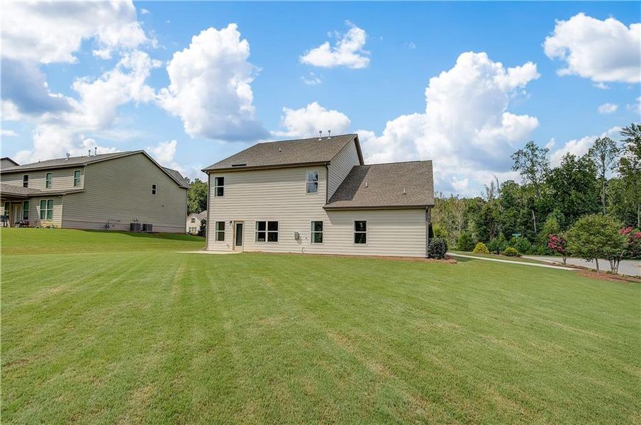 Front exterior of a new home in Traditions at Crystal Lake, Hampton, GA, highlighting curb appeal (Image 15). Front exterior of a new home in Traditions at Crystal Lake, Hampton, GA, highlighting curb appeal (Image 15).