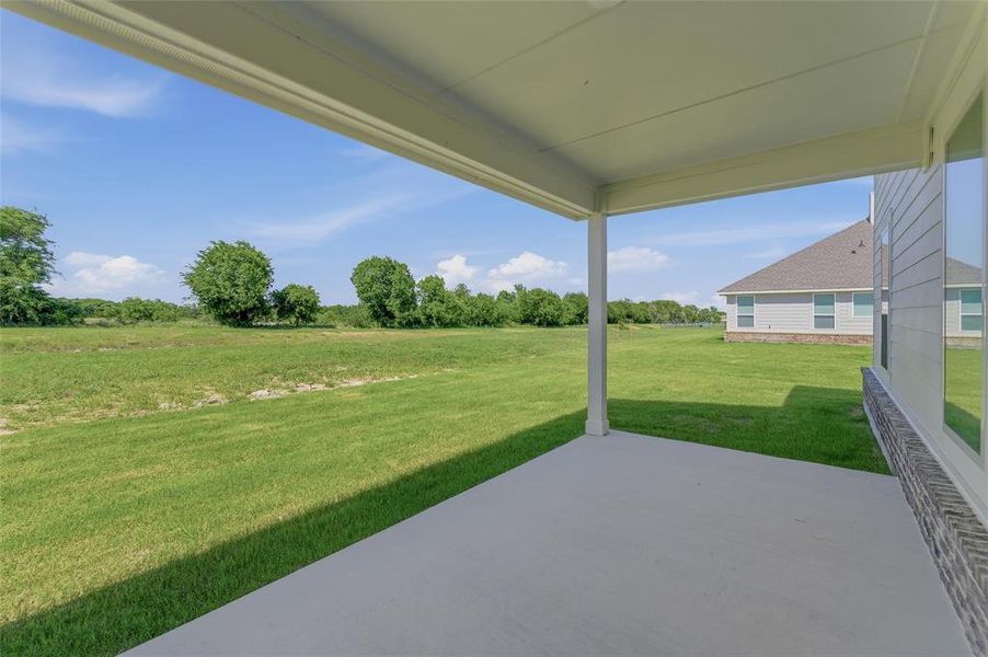 Covered patio featuring a concrete slab and white support columns