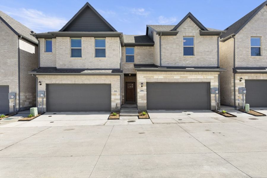 Front exterior of a new home in Sereno Oaks at Buckner Terrace, Dallas, TX, highlighting curb appeal (Image 1). Front exterior of a new home in Sereno Oaks at Buckner Terrace, Dallas, TX, highlighting curb appeal (Image 1).