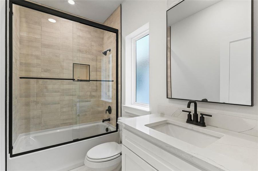 Bathroom featuring vanity and bath / shower combo with glass door Bathroom featuring vanity and bath / shower combo with glass door