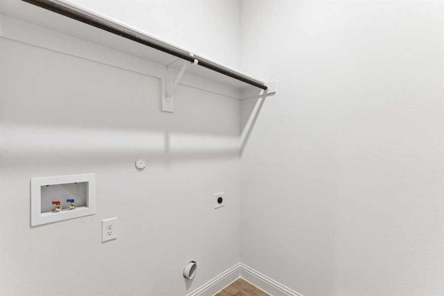 Laundry room with dryer hookup, hookup for an electric dryer, washer hookup, and wood finished floors